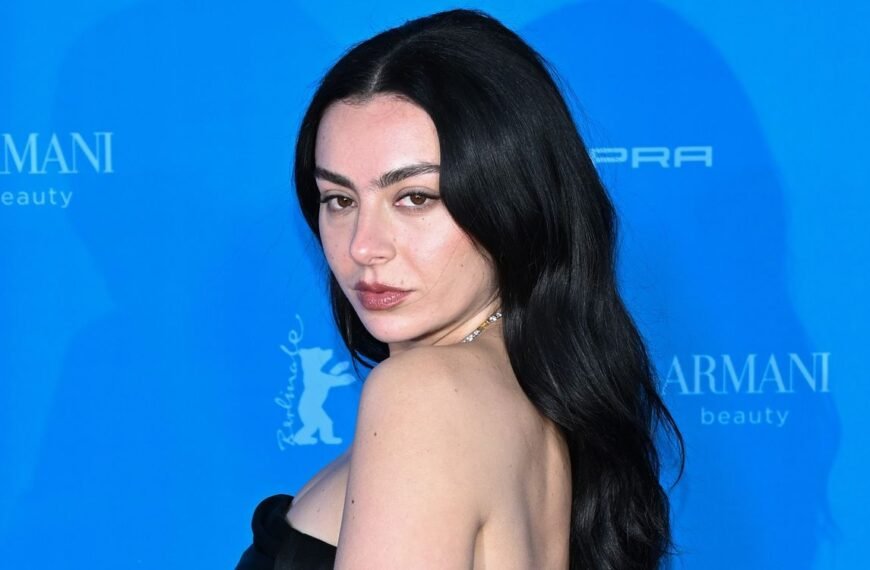 Charli XCX Shines in a Chic Strapless Satin Dress with Stunning Diamond Accessories