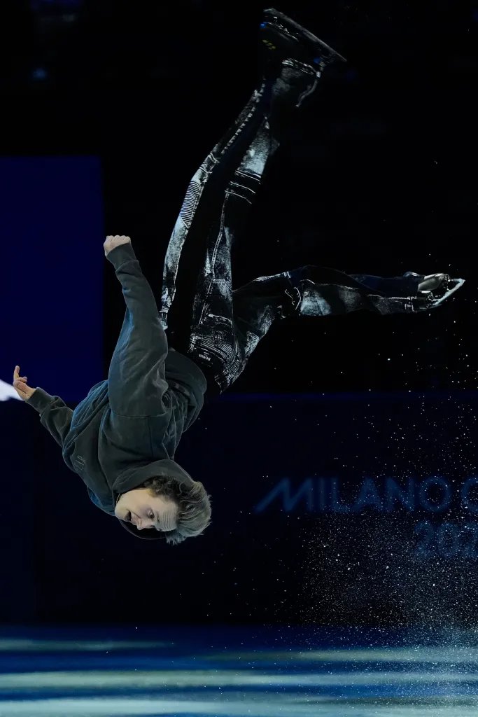 Ilia Malinin doing a backflip during his performance at the 2026 Winter Olympics figure skating exhibition.