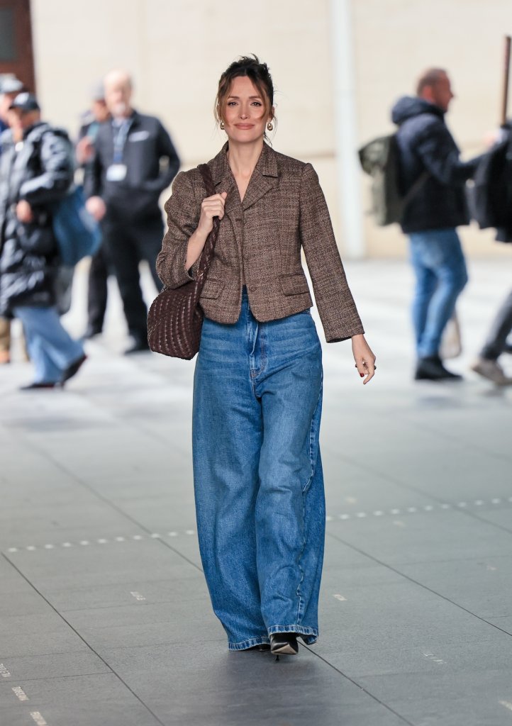 Rose Byrne wearing a brown tweed jacket and wide-leg blue jeans at BBC Radio 2.