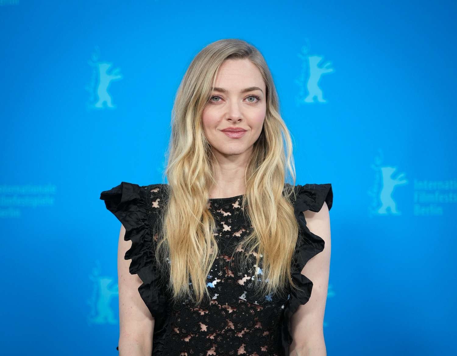 Amanda Seyfried Stuns in Black Lace Dress with Vibrant Blue Lingerie Peeking Through