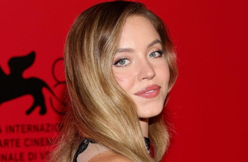 Sydney Sweeney’s Chic Look: Lacy White Bra, Glamorous Curls, and Bold Red Nails