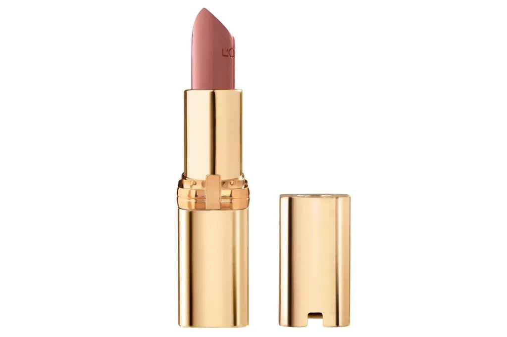 A gold lipstick tube with the cap off, revealing a nude pink lipstick bullet.