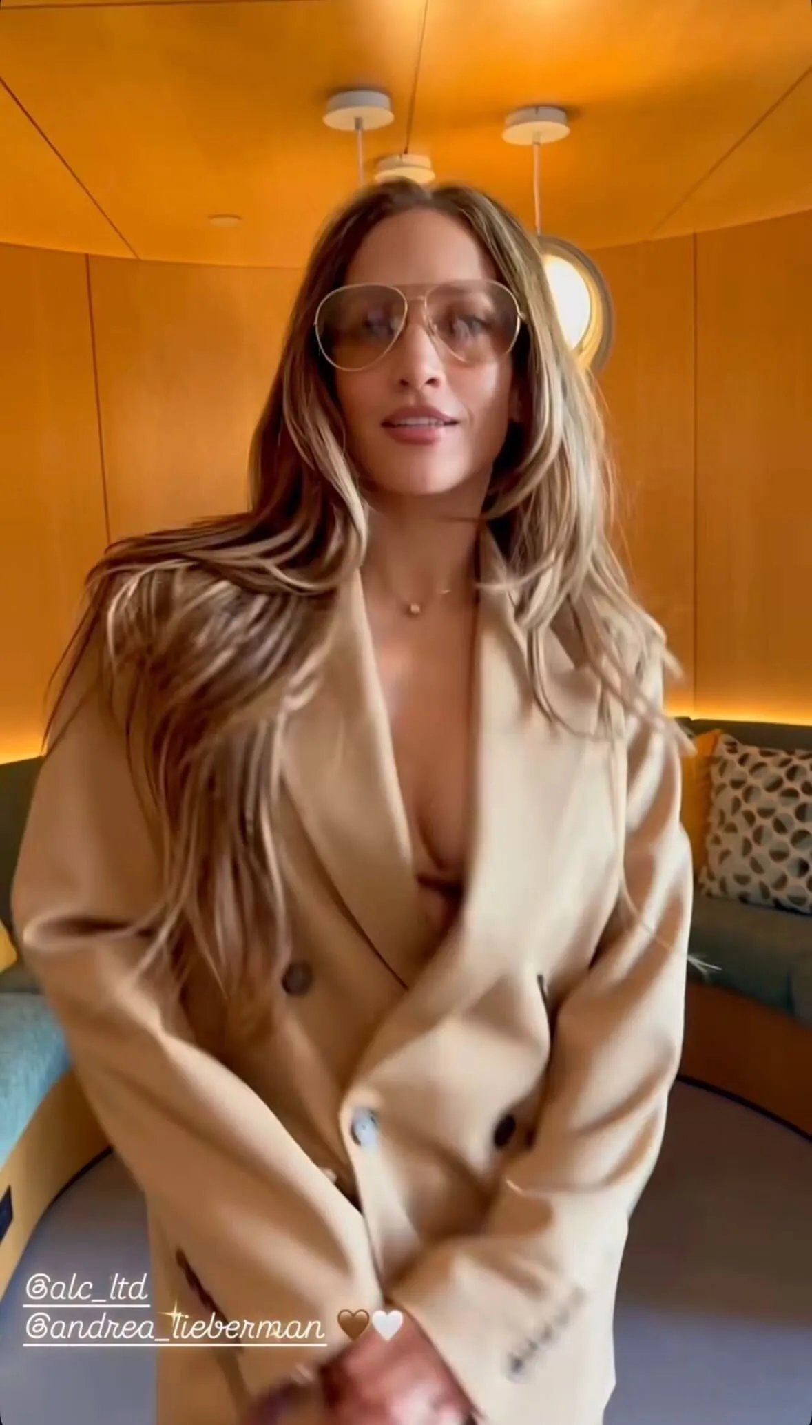 Jennifer Lopez in a plunging A.L.C. suit and her cognac Hermes Birkin bag