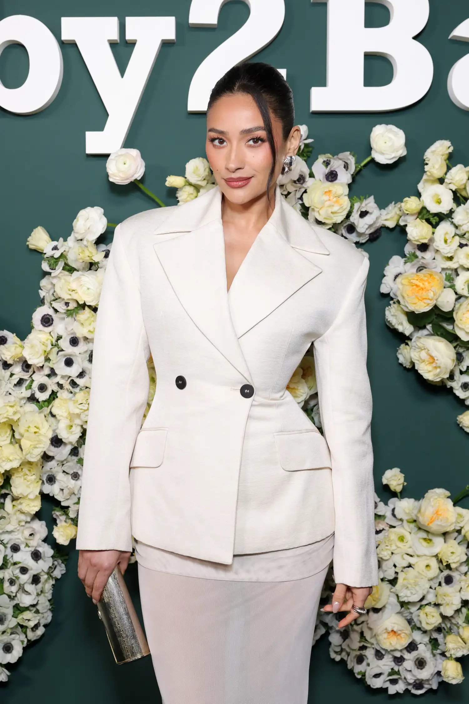 Shay Mitchell wearing a white pantsuit