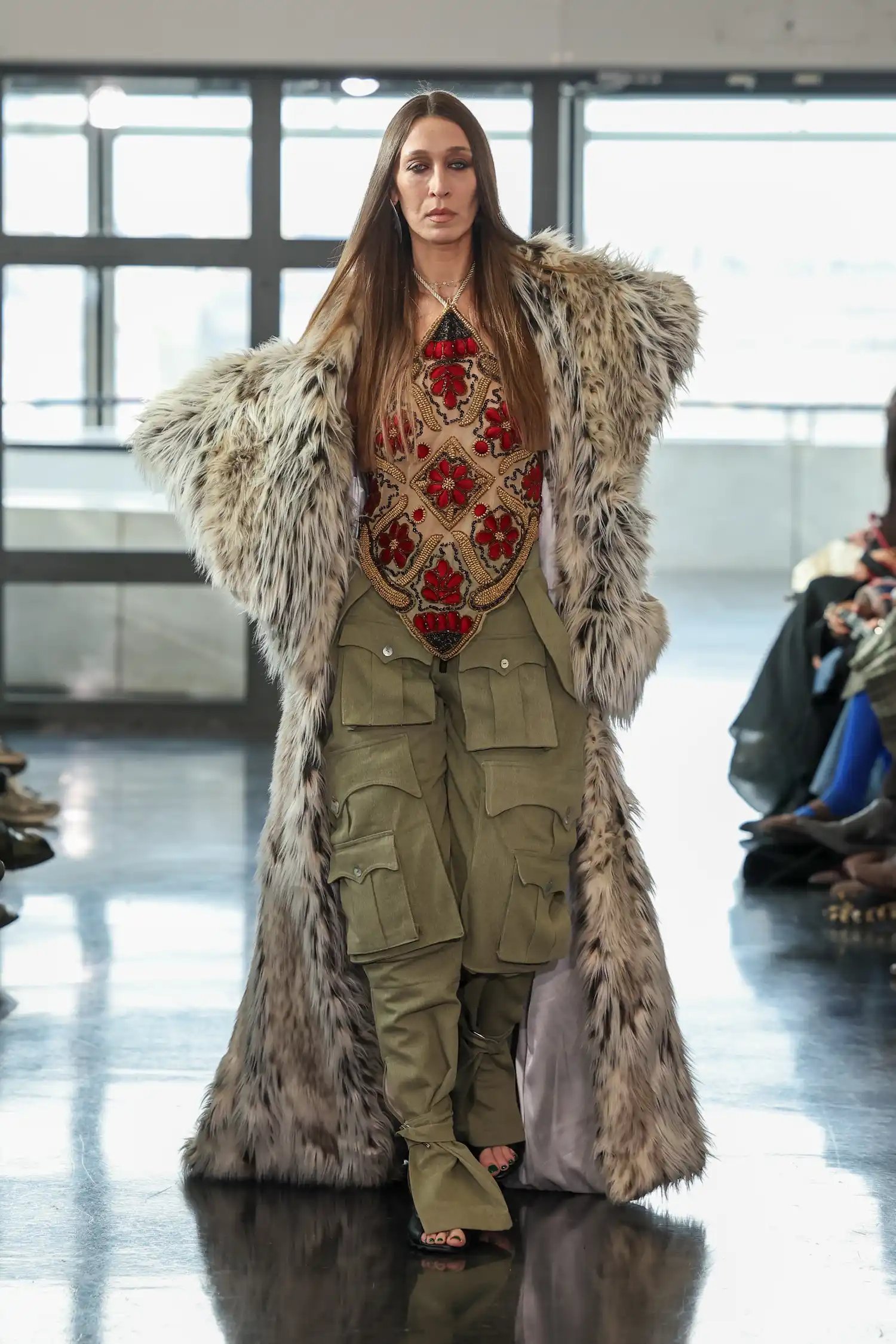 Alana Hadid in a sequin top and cargo pants on the runway