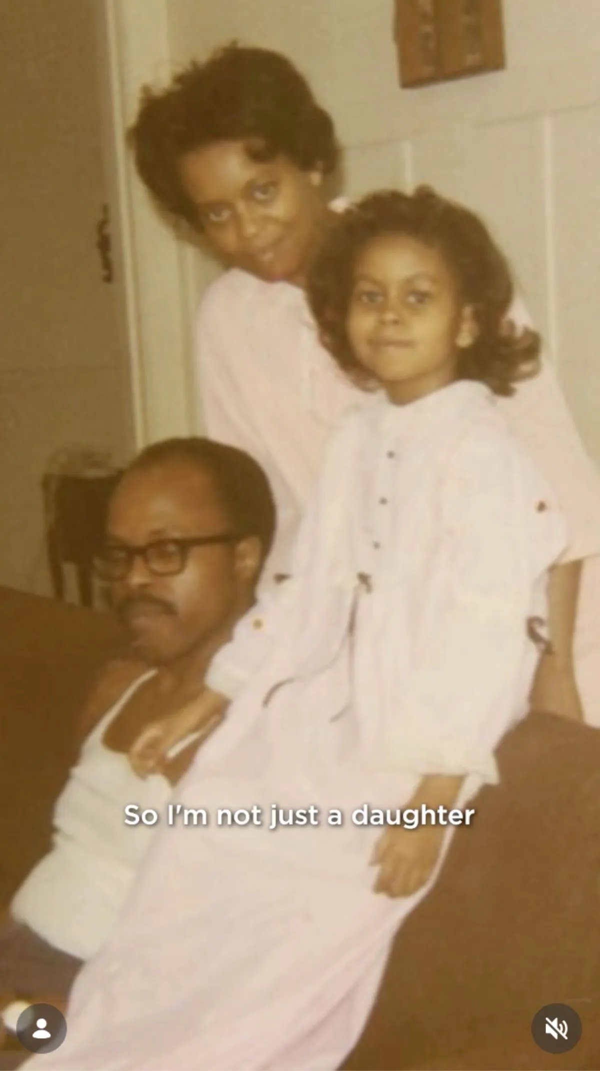 Michelle Obama poses for a photo as a child alongside her mother Marian Robinson and her father Fraser C. Robinson III.