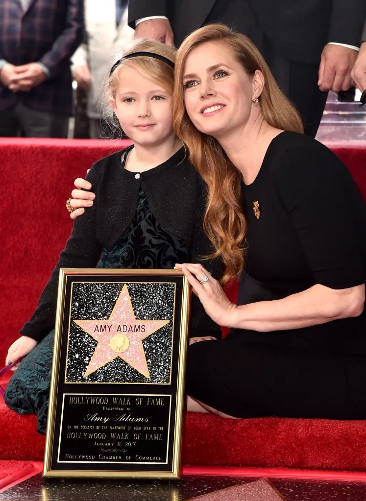 Actress Amy Adams with her daughter Aviana, holding a plaque celebrating Adams's star on the Hollywood Walk of Fame.