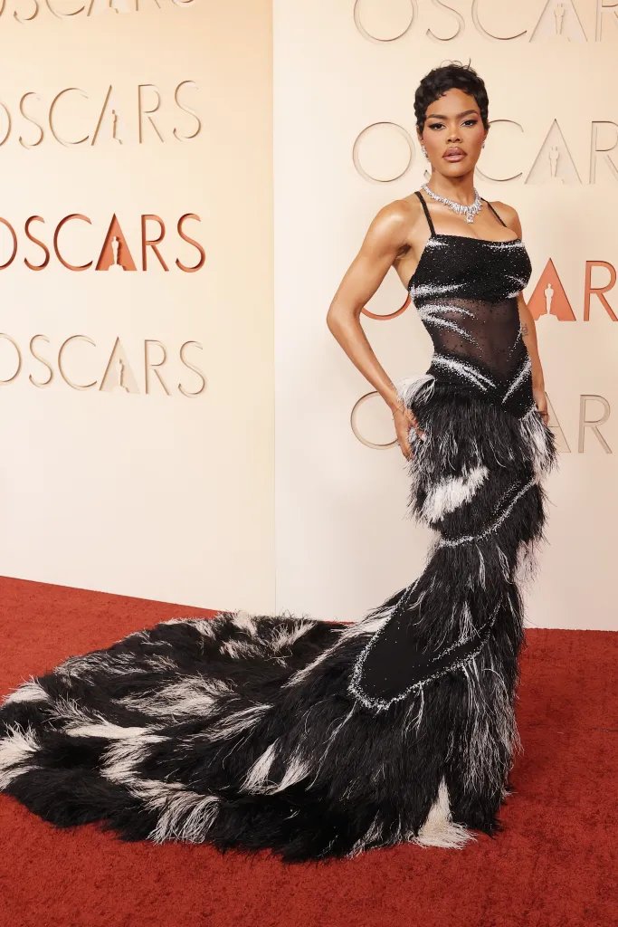 Teyana Taylor in a black and white feathered gown on the Oscars red carpet.