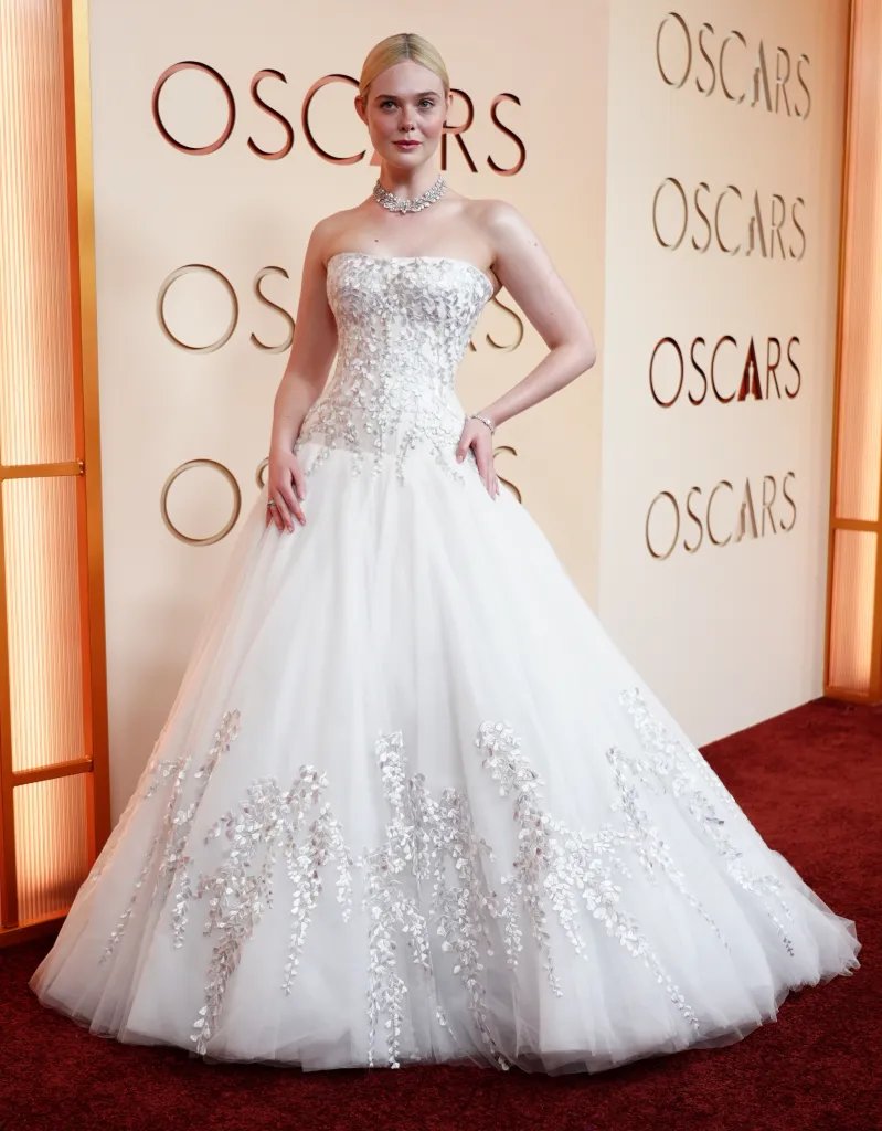 Elle Fanning in a white strapless gown with silver leaf embellishments at the Oscars.