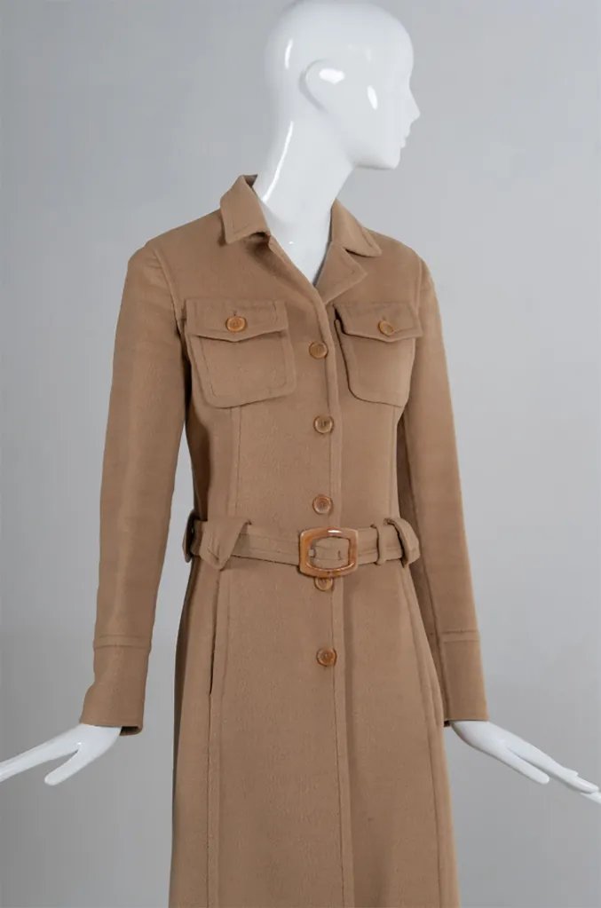 Carolyn Bessette Kennedy's Prada single-breasted coat from 1996, a tan full-length coat on a mannequin.