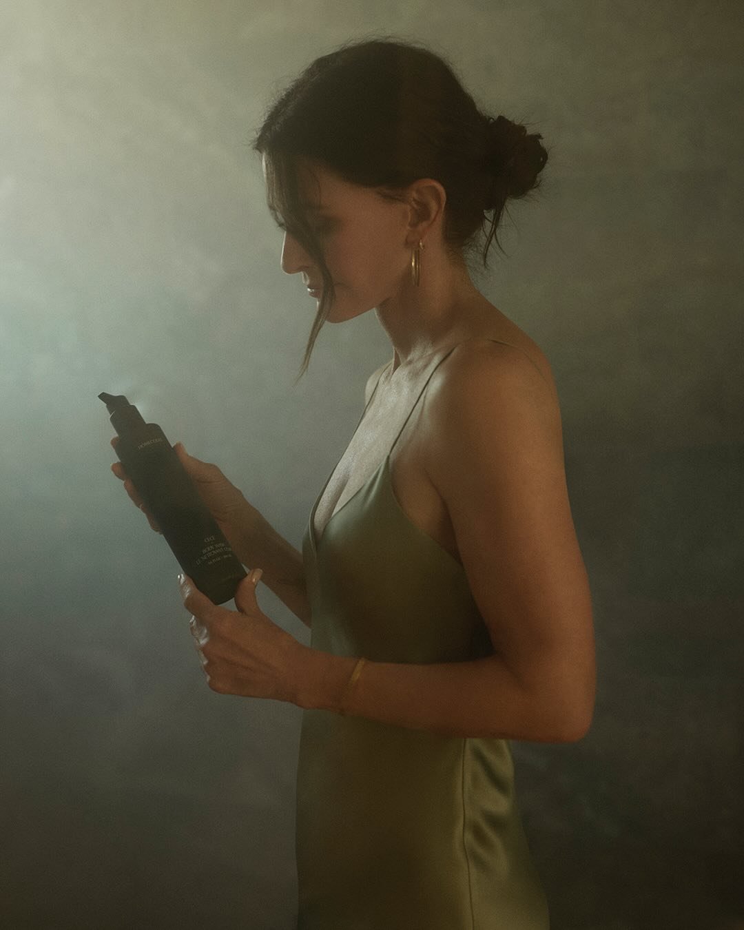Woman in a green dress holding a Homecourt product.
