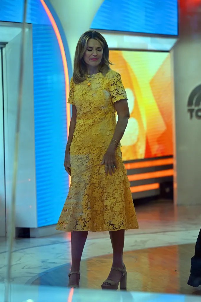 Savannah Guthrie in a yellow lace dress and beige platform heels.