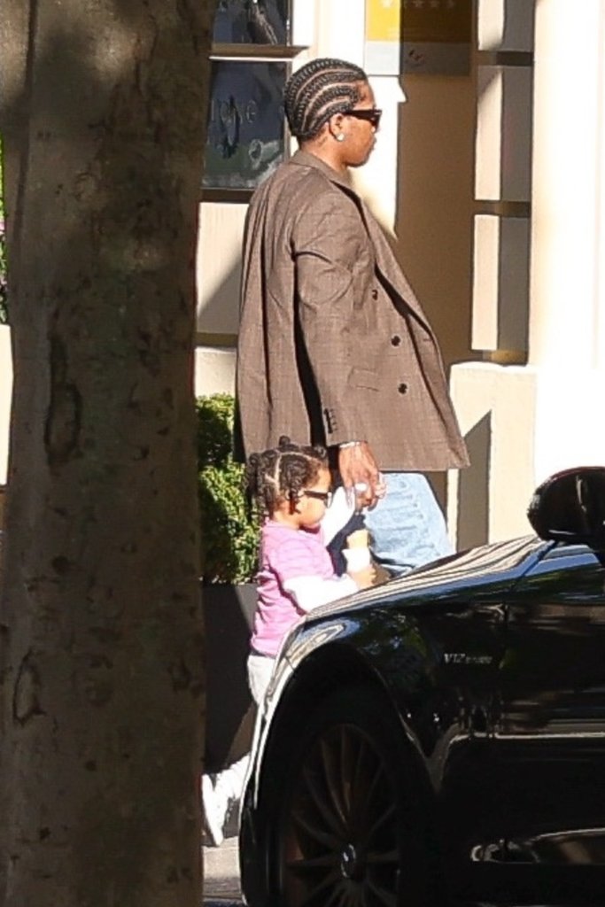 ASAP Rocky in a brown suit and sunglasses with Rocki Irish Mayers in a pink top.
