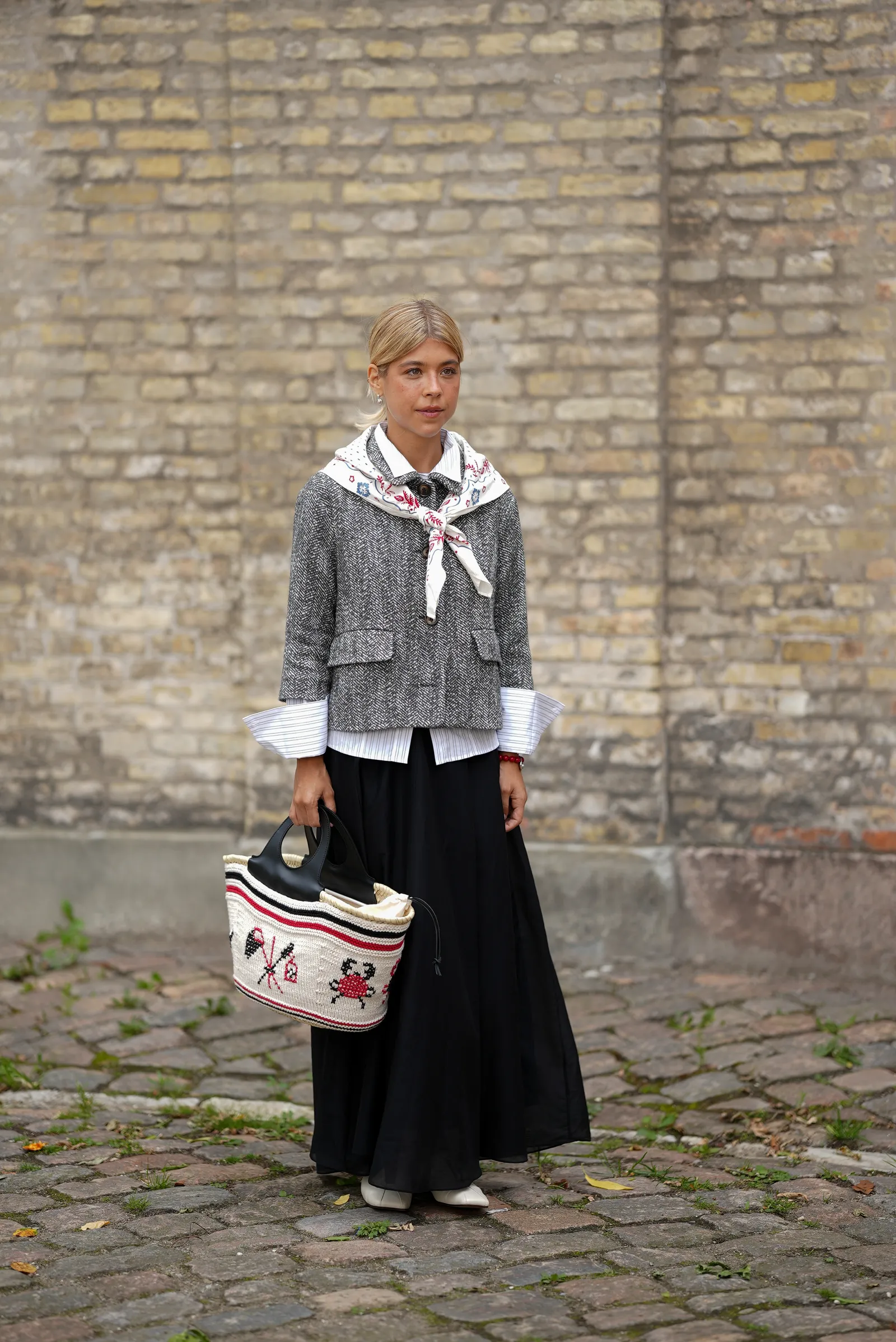 Copenhagen Fashion Week attendee with a fashion scarf draped over her shoulders