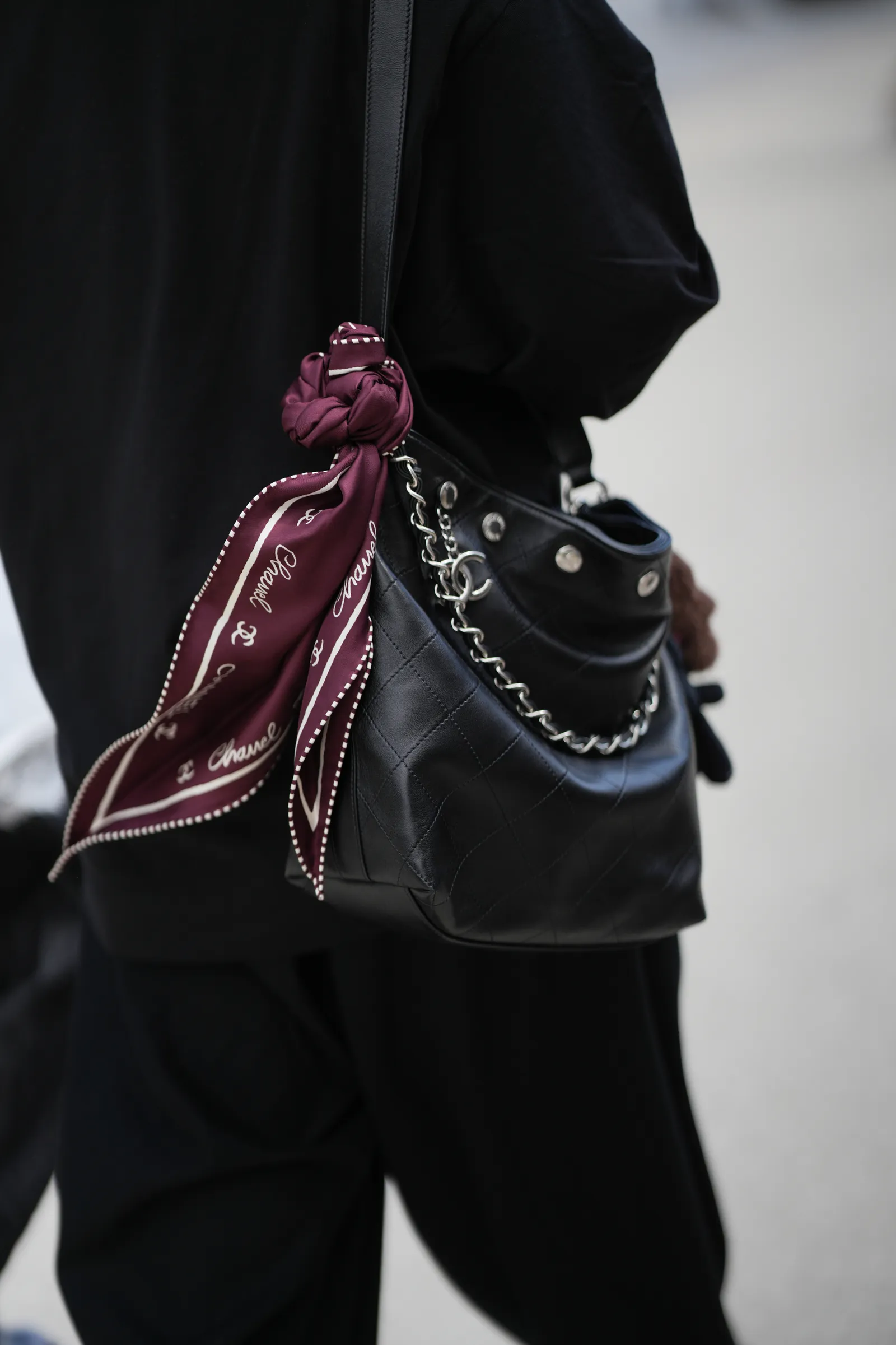 Silk scarf tied to the handle of a bag