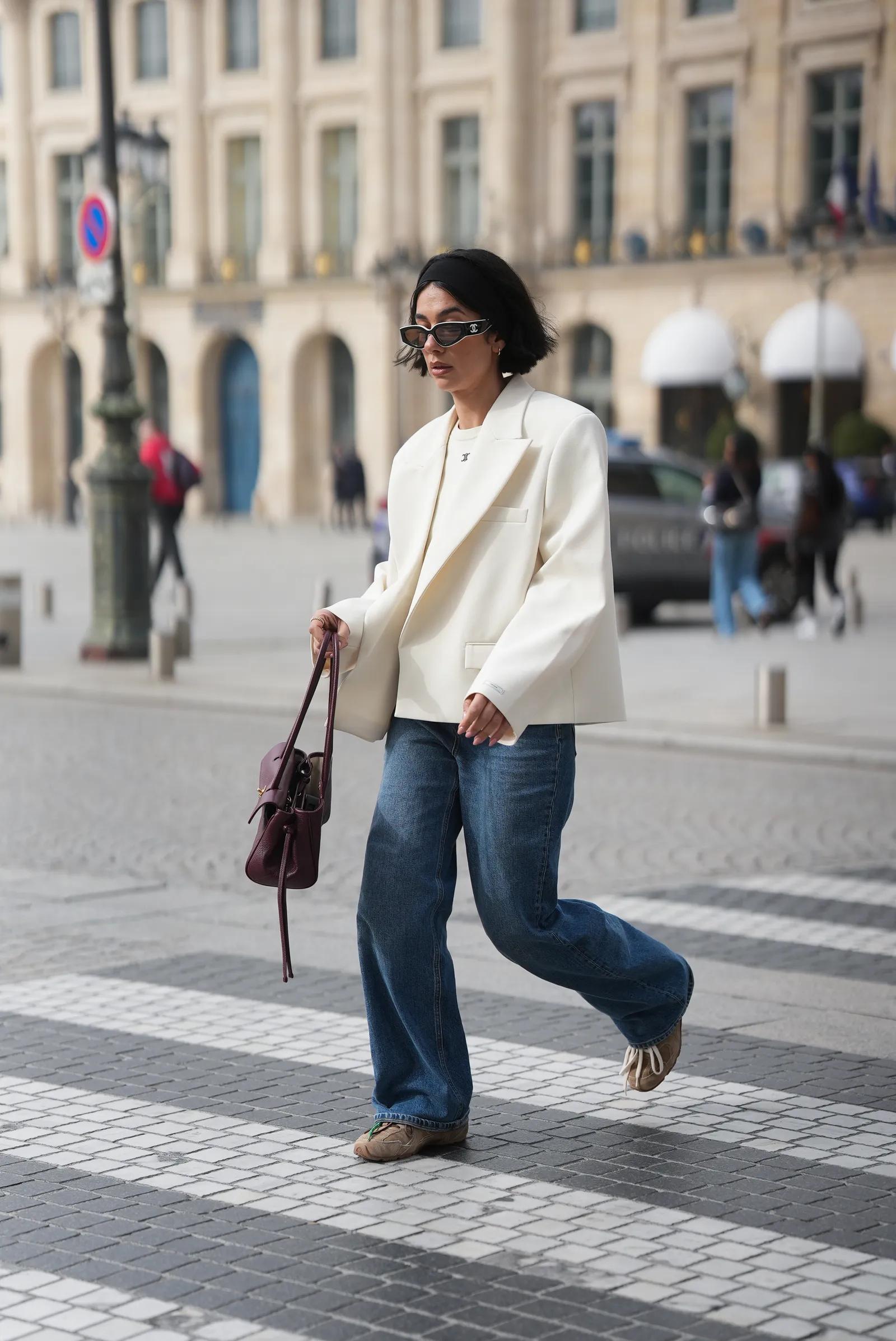 PARIS FRANCE MARCH 7 Nadine Koca is seen wearing a white tailored blazer with wide structured lapels padded shoulders...