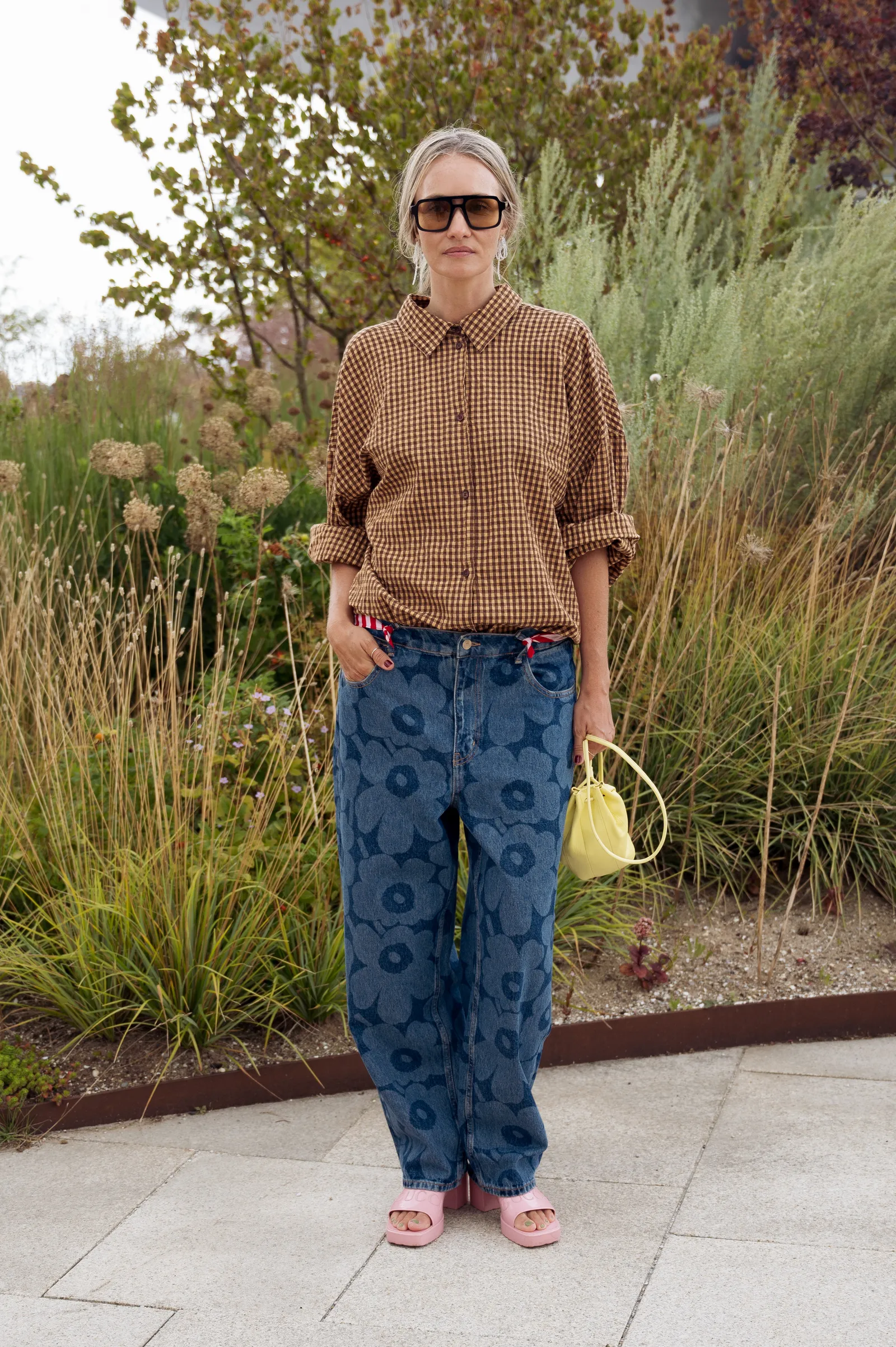 COPENHAGEN DENMARK  AUGUST 08 A guest wears blue jeans with flower pattern brown and beige shirt...