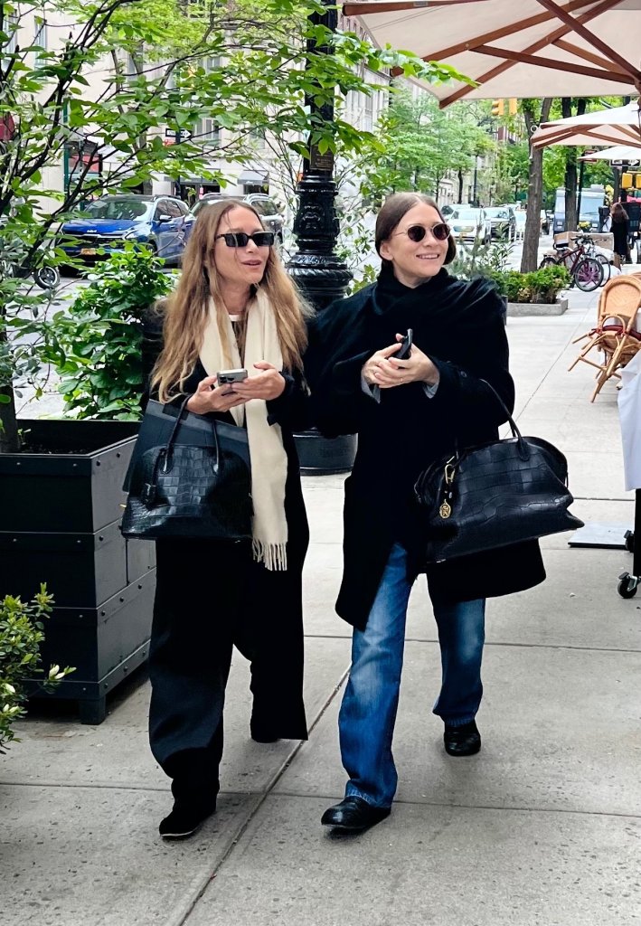 Mary-Kate and Ashley Olsen walking together in Midtown Manhattan.