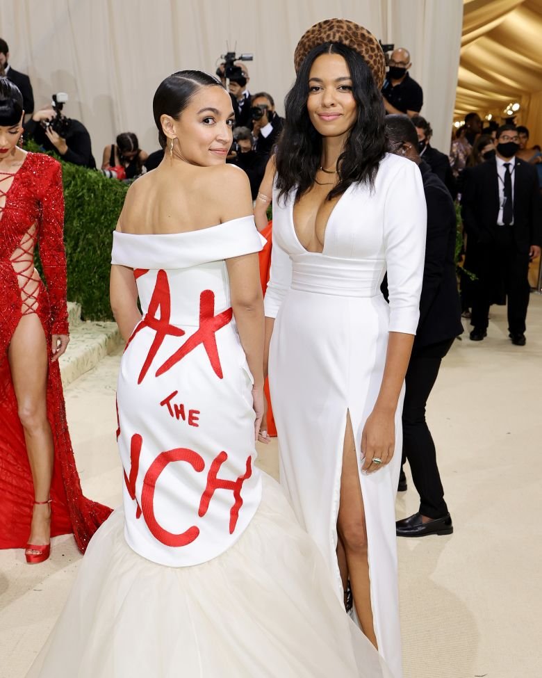 Alexandria Ocasio-Cortez, left, and designer Aurora James at the Met Gala in 2021. Ocasio-Cortez's dress, by James, reads 'TAX THE RICH.'