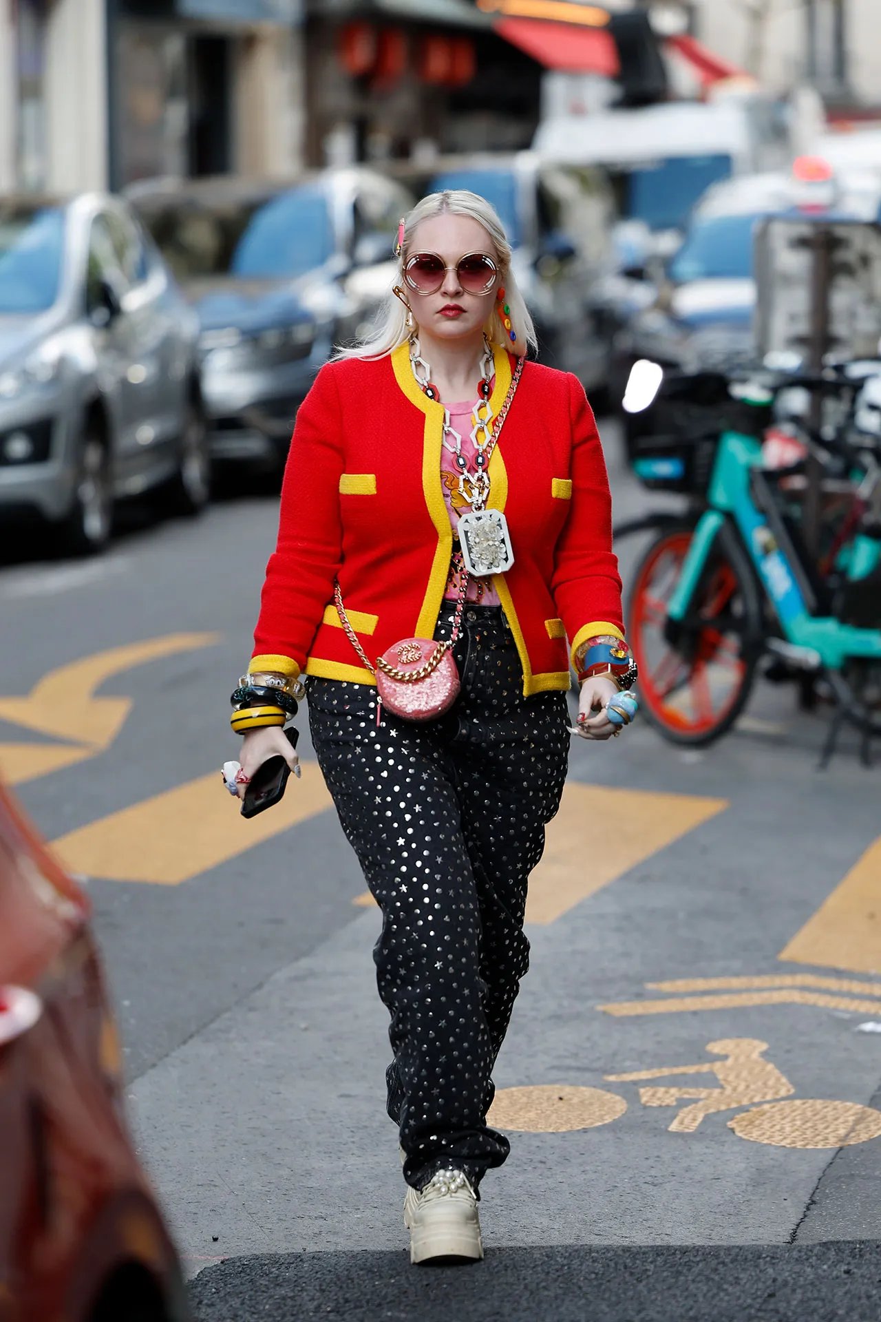 Image may contain Adult Person Pedestrian Clothing Pants Machine Wheel Coat and Accessories