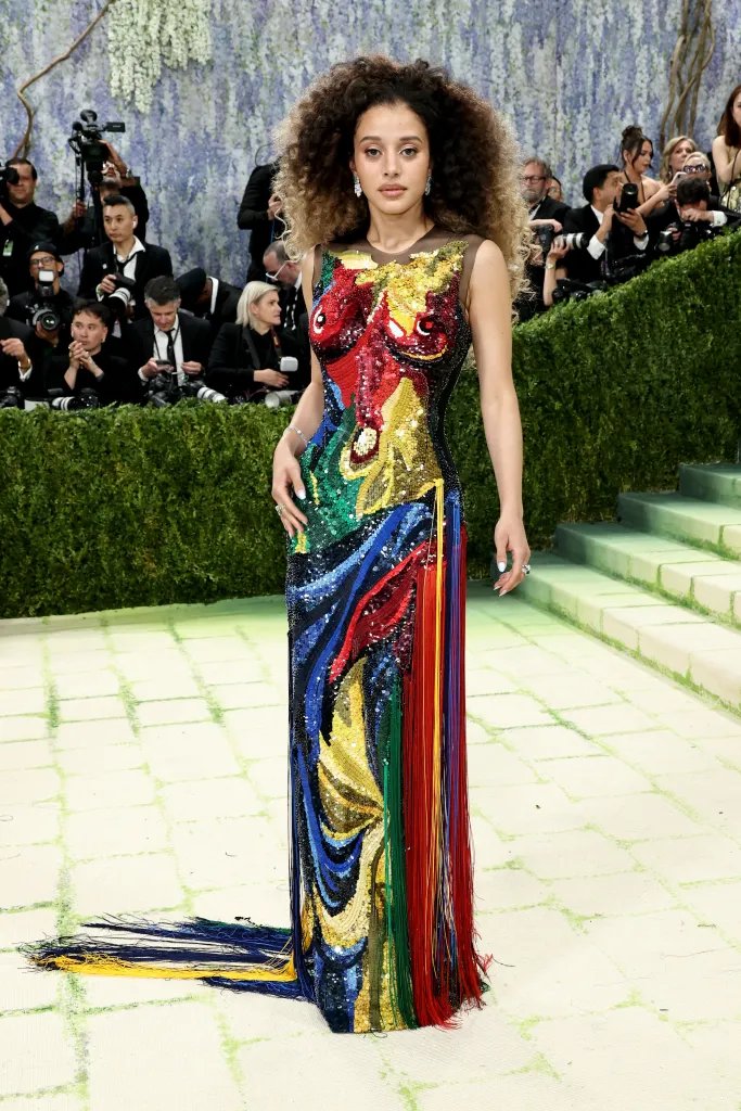 Chase Infiniti in a colorful sequined gown with long tassels at the Met Gala.