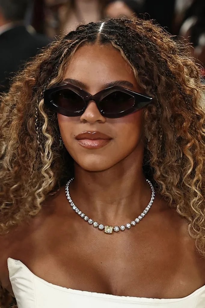 Blue Ivy Carter wearing sunglasses and a diamond necklace with a yellow diamond at the Met Gala 2026.