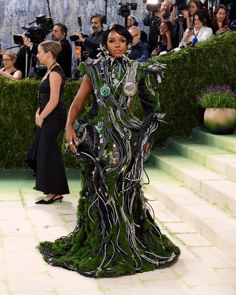Janelle Monáe on the Met Gala red carpet in a green dress covered in computer wires.