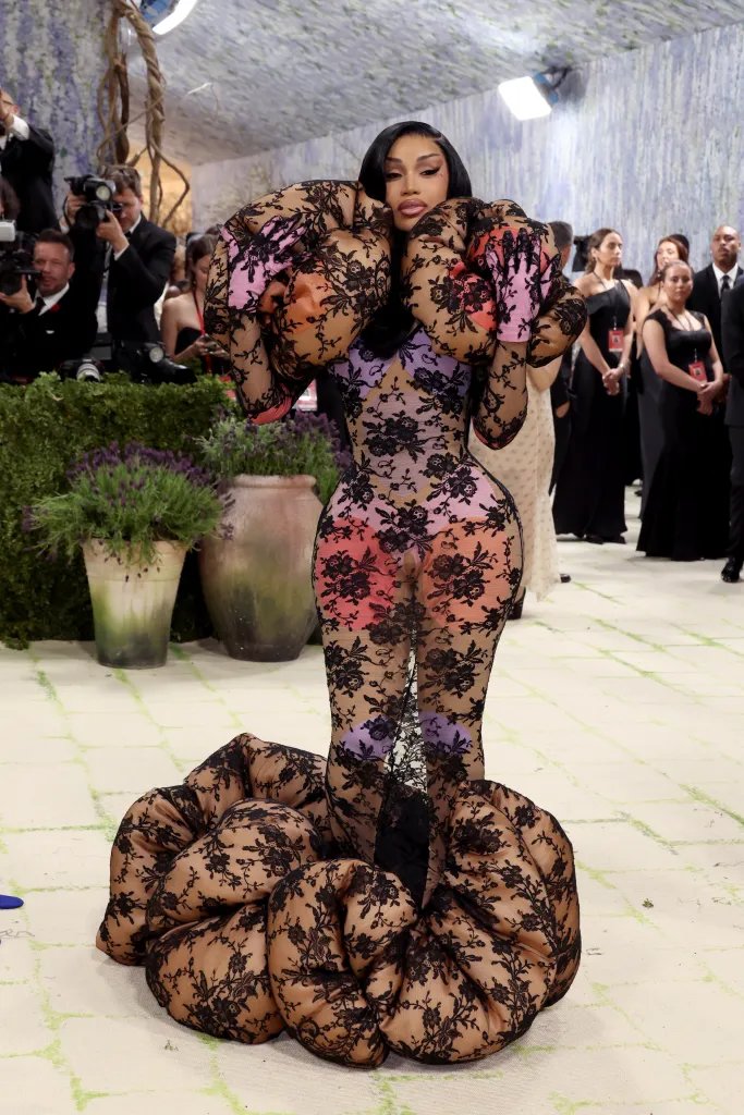 Cardi B poses in a sheer black lace gown at the 2026 Met Gala.