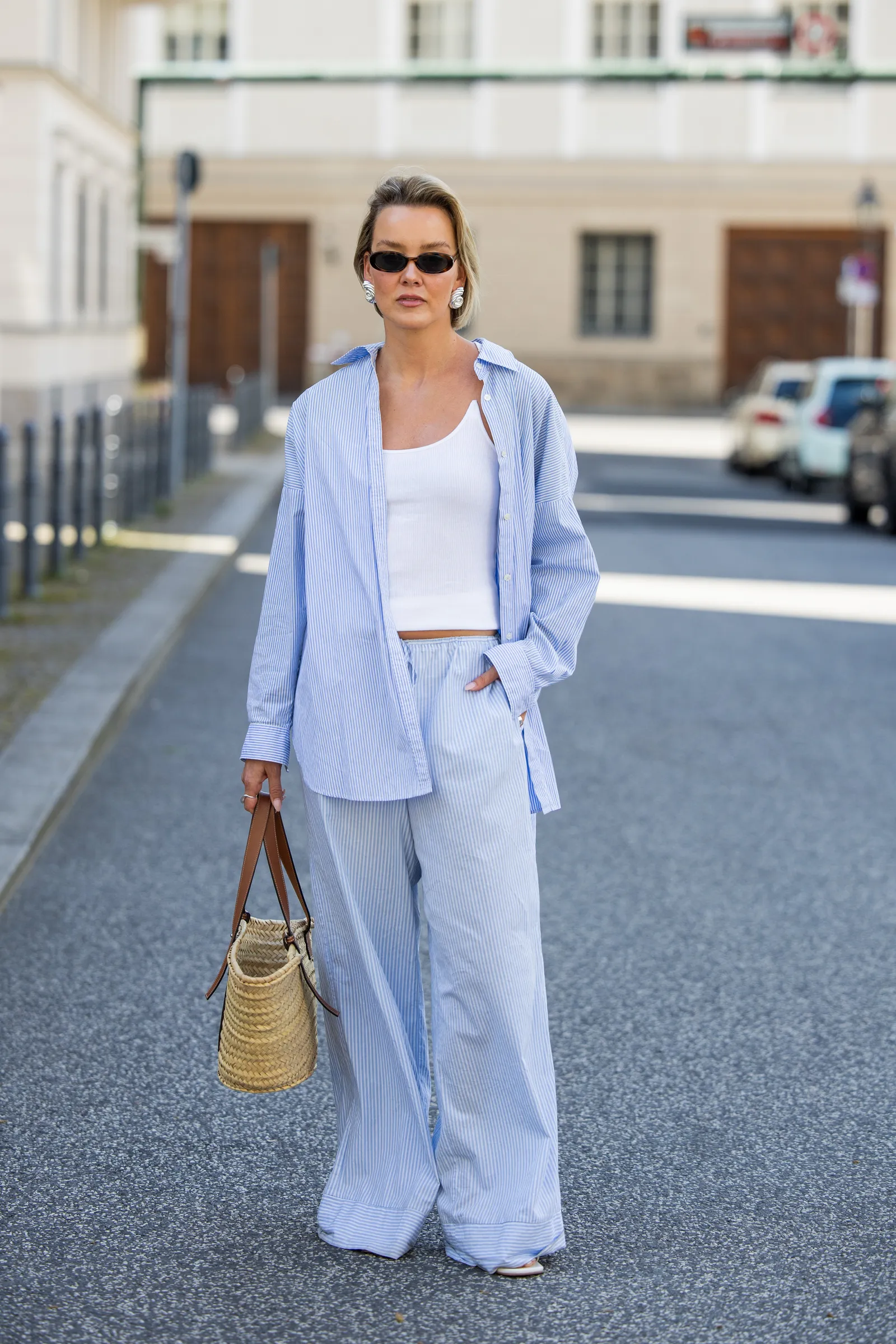 Image may contain Clothing Pants Blazer Coat Jacket Jeans Accessories Bag Handbag Person and Standing