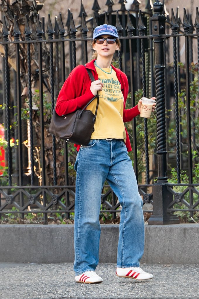 Jennifer Lawrence walking in New York City with a coffee.