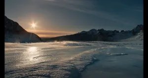 Strong winds lift snow off a glacial cap on a sunny day in Iceland in ‘Time and Water’