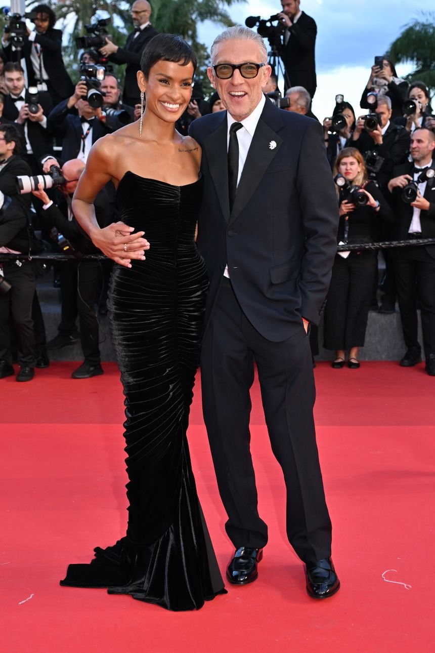 Vincent Cassel in a classic suit and Narah Baptista in a ruched velvet strapless dress.